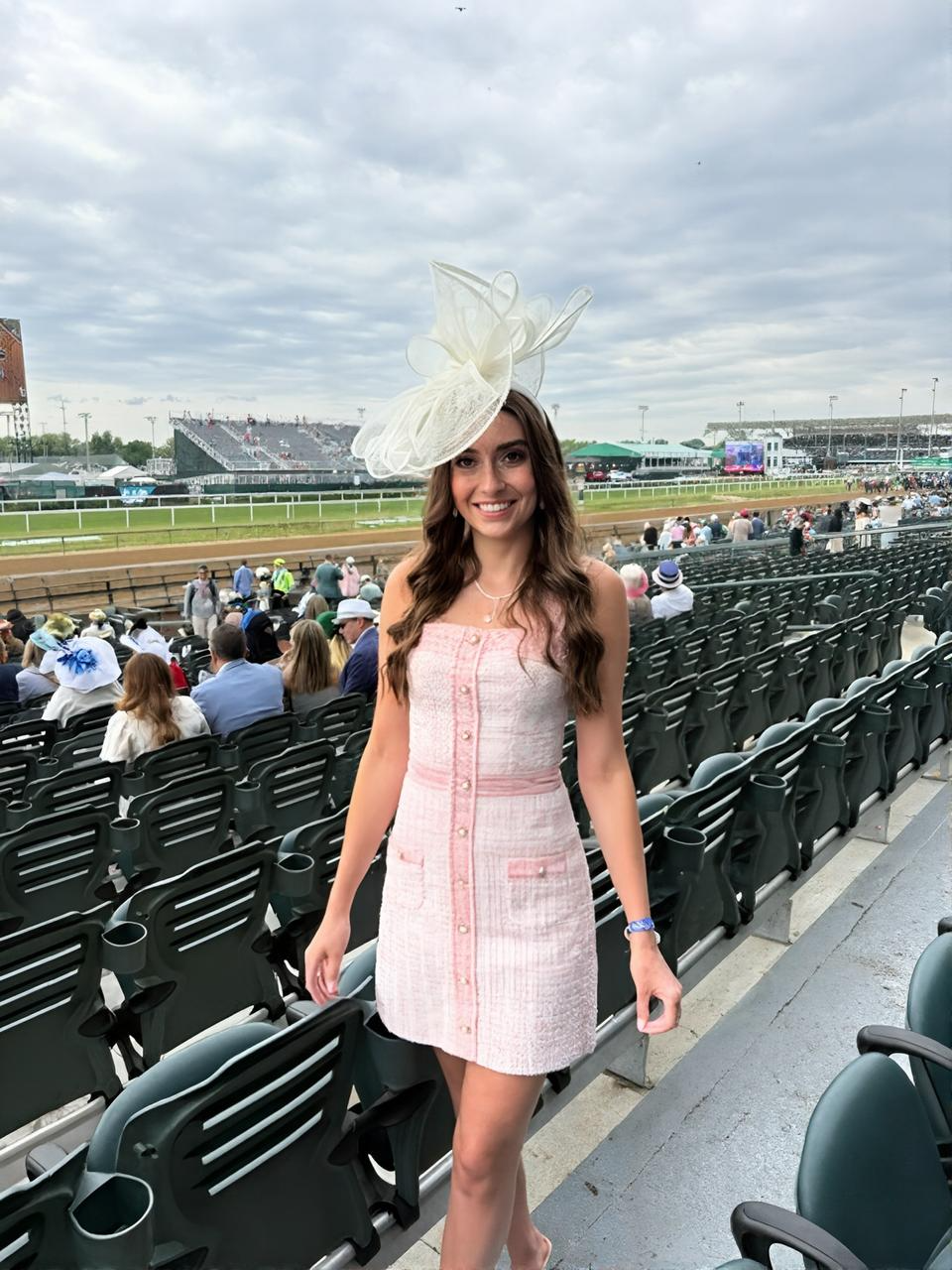 Race day portrait in pink tweed dress and fascinator at the Churchill Downs grandstand